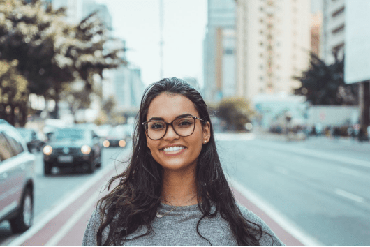 Smiling girl wearing glasses. 